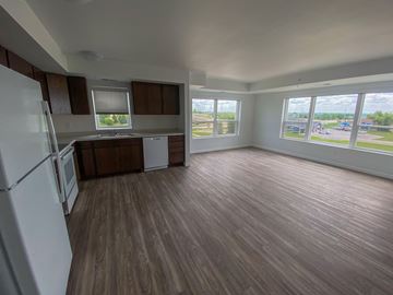 Rochester apartment for rent - A kitchen with a white refrigerator and wooden floors.