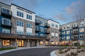 Oakdale apartment for rent - The image shows the exterior of Oakdale Commons apartment building at dusk.