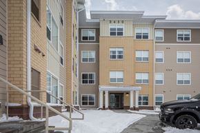 Rochester apartment for rent - A black car is parked in front of a building with the number 3450 on it.
