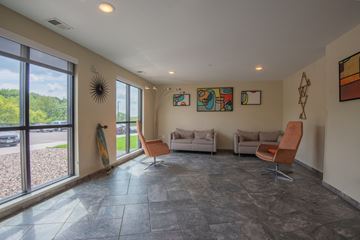 Rochester apartment for rent - a living room with couches and chairs and a large window