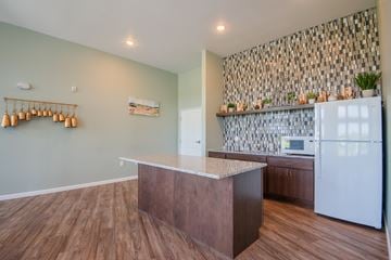 Mankato apartment for rent - A kitchen with a white refrigerator and wooden floors.