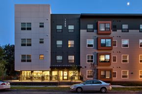 Saint Paul apartment for rent - A modern apartment building named Thomas Avenue is shown with a car parked in front.