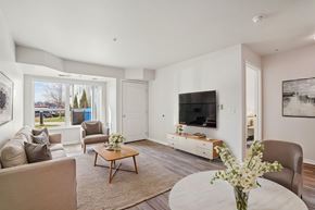 Newport apartment for rent - A living room with a brown sofa, a white coffee table, and a flat screen TV.