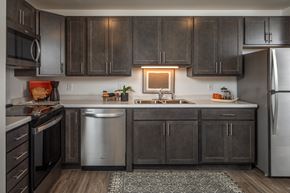 St. Paul apartment for rent - A modern kitchen with dark wood cabinets and stainless steel appliances.