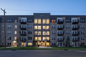 Bloomington apartment for rent - an apartment building with its windows lit up at dusk
