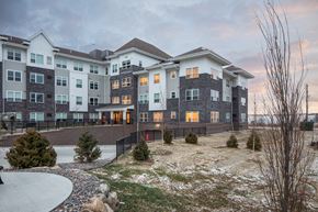 Newport apartment for rent - A large, modern apartment complex with a mix of grey and beige exterior walls.