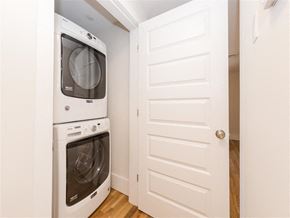 Cambridge apartment for rent - a laundry room with a white door and a washer and dryer