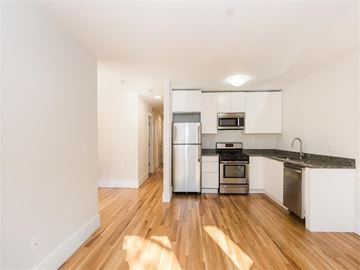 Cambridge apartment for rent - a kitchen with stainless steel appliances and a hard wood floor