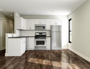 Cambridge apartment for rent - a kitchen with white cabinets and stainless steel appliances