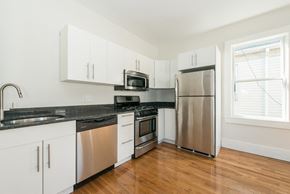 Cambridge apartment for rent - A kitchen with white cabinets and stainless steel appliances.