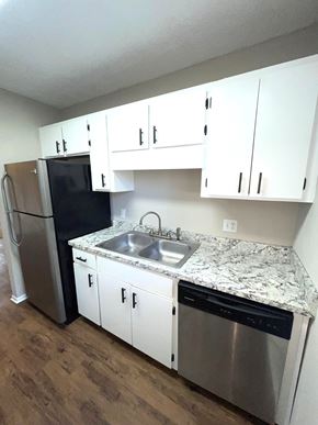 Valdosta apartment for rent - A kitchen with a granite counter top and stainless steel appliances.