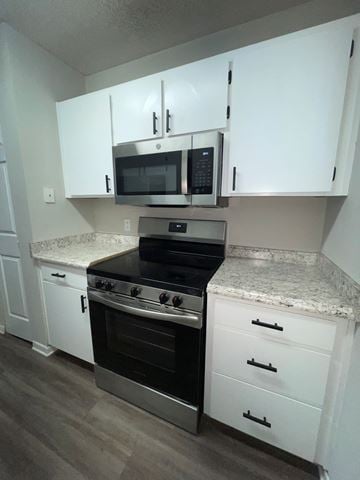Valdosta apartment for rent - A kitchen with white cabinets and a granite countertop.