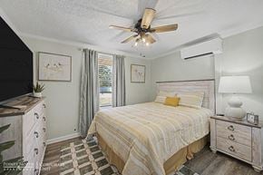 Albany apartment for rent - A bedroom with a bed, dresser, and ceiling fan.