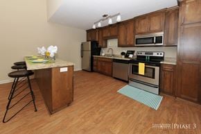 Albany apartment for rent - a kitchen with wooden cabinets and stainless steel appliances
