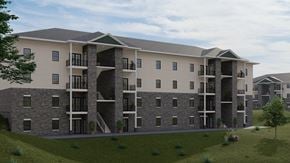 Shelbyville apartment for rent - A large apartment complex with multiple balconies and doors.