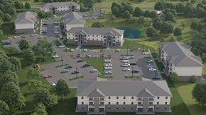 Shelbyville apartment for rent - A rendering of a large building complex with a parking lot in front.