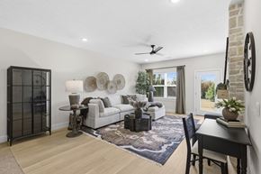 Richfield apartment for rent - A living room with a white couch, a black chair, and a rug.