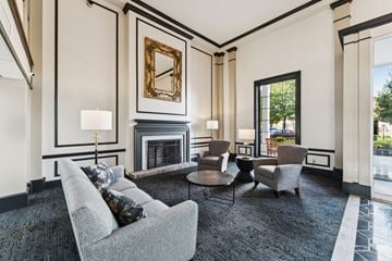Rocky River apartment for rent - A living room with a grey couch, a fireplace, and a painting on the wall.