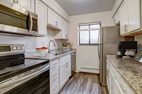 Rocky River apartment for rent - A kitchen with white cabinets and a black stove top oven.