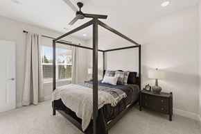 Richfield apartment for rent - A bedroom with a four poster bed and a nightstand with a lamp.