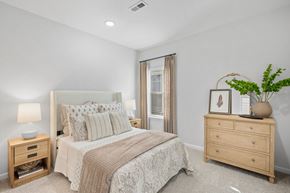 Asheville apartment for rent - A bedroom with a bed, nightstand, and a plant on a dresser.
