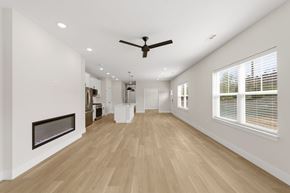 Richfield apartment for rent - A spacious room with a fireplace and a ceiling fan.