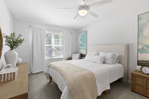 Asheville apartment for rent - A bedroom with a large bed and a ceiling fan.