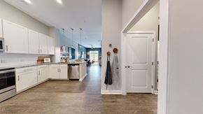 Chapel Hill apartment for rent - A kitchen with white cabinets and a wooden floor.