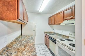 Amherst apartment for rent - A kitchen with granite countertops and white appliances.