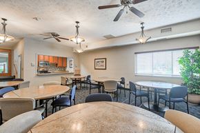 Pittsburgh apartment for rent - A dining room with a table surrounded by chairs and a ceiling fan.