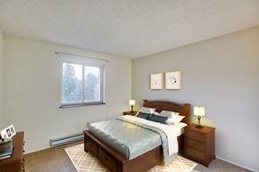 Pittsburgh apartment for rent - A bedroom with a bed, nightstand, and window.