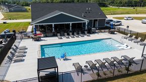 Beavercreek apartment for rent - A pool with a black fence and a black and white striped poolside.