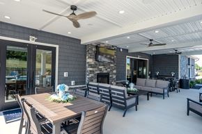 Beavercreek apartment for rent - A modern outdoor dining area with a wooden table and chairs.