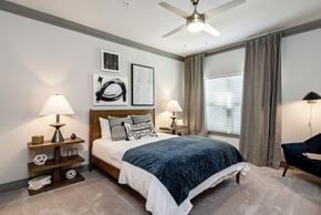 Huntersville apartment for rent - a bedroom with a bed and a ceiling fan