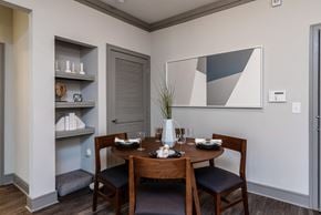 Huntersville apartment for rent - a dining area with a wooden table and chairs and a wall shelf