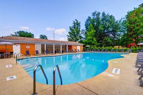 Rocky River apartment for rent - A large outdoor swimming pool with a building in the background.