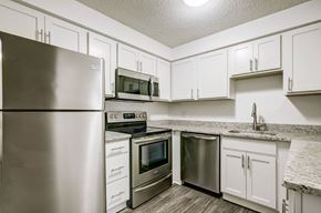 Lakewood apartment for rent - a kitchen with stainless steel appliances and white cabinets