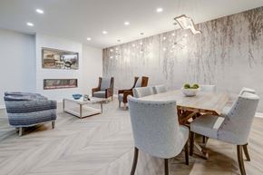 Lakewood apartment for rent - a dining room with a wooden table and chairs and a fireplace