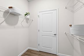 Brook Park apartment for rent - A white door is in the middle of a room with a shelf above it.