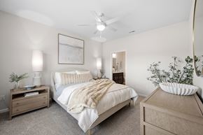 Brook Park apartment for rent - A bedroom with a bed, nightstands, and a ceiling fan.