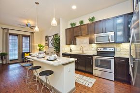 Spring apartment for rent - a kitchen with an island and a table with chairs