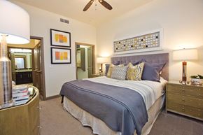 Spring apartment for rent - a bedroom with a bed and a ceiling fan