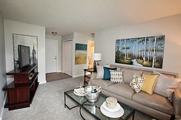 Mayfield Heights apartment for rent - A living room with a couch, coffee table, and a painting on the wall.