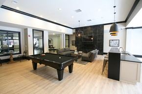Rocky River apartment for rent - A black pool table in the middle of a room with a bar area.