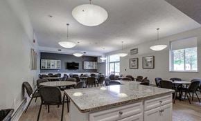 Pittsburgh apartment for rent - A kitchen with a large island and chairs around it.