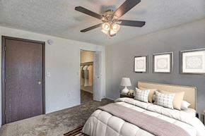 Pittsburgh apartment for rent - A bedroom with a bed, a ceiling fan, and pictures on the wall.