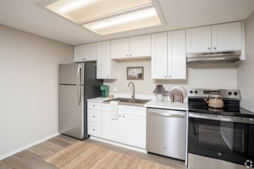 Cuyahoga Falls apartment for rent - A kitchen with white cabinets and stainless steel appliances.