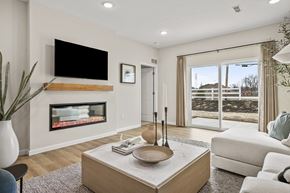 Brook Park apartment for rent - A modern living room with a fireplace and a flat screen TV mounted above it.