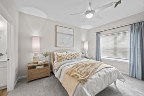 Beavercreek apartment for rent - A bedroom with a large bed and a ceiling fan.