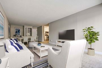 Lakewood apartment for rent - a living room with white furniture and a tv